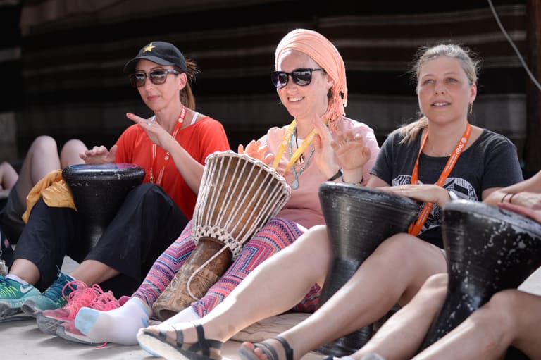 Momentum participants in a drumming session together